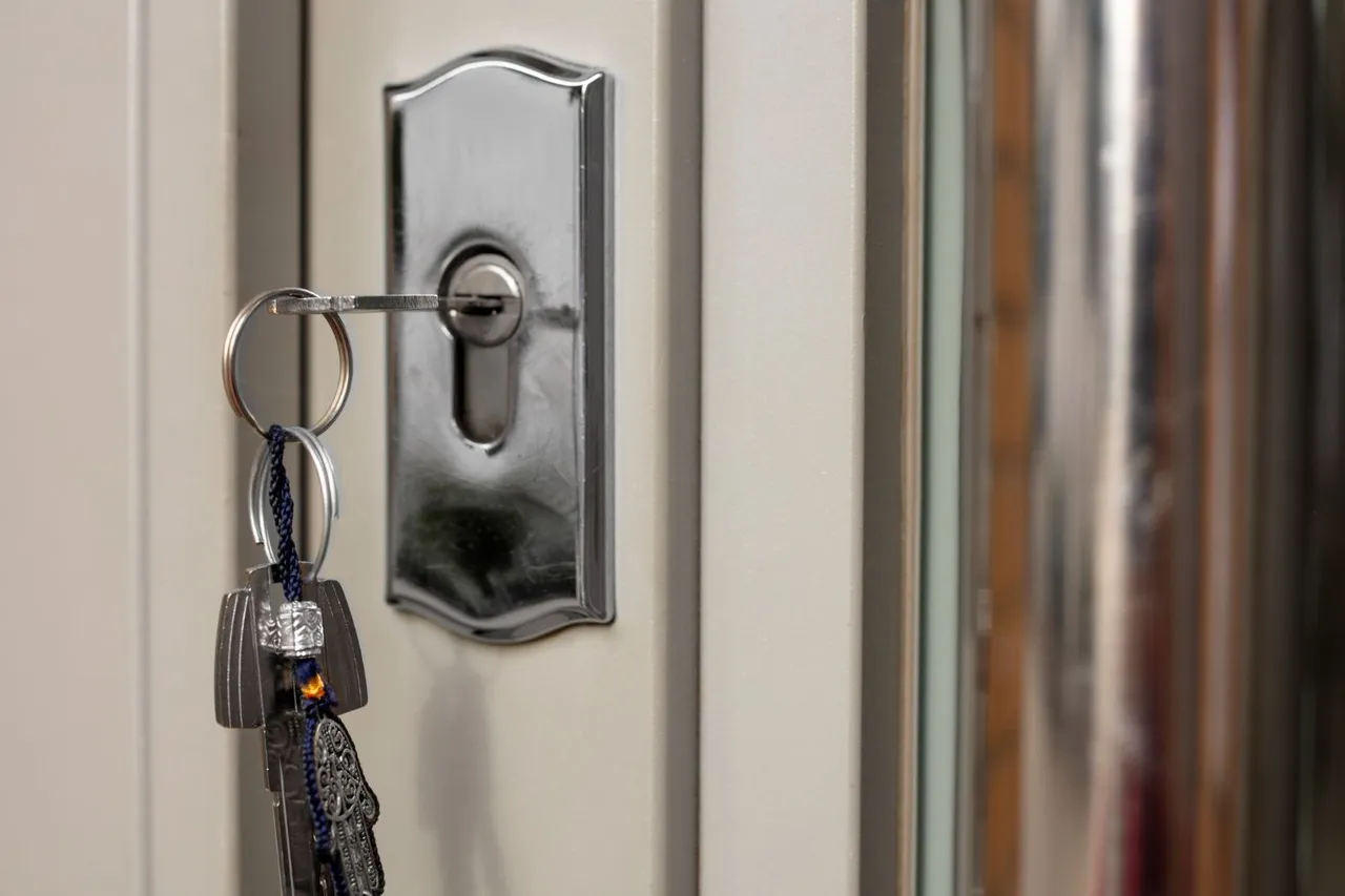 A close up of a key in a door lock.