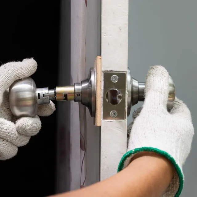 Locksmith removing a door lock cylinder to rekey it in Montgomery, AL